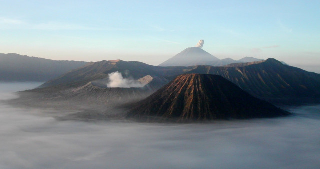 Mount Bromo at sunrise showing its volcanoes and Mount Semeru background