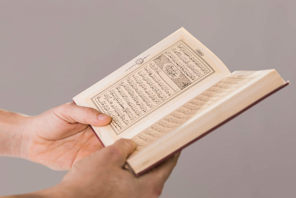 Quran being held hands close up 1600 1067