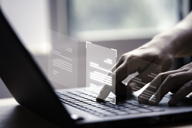 Handusinglaptopcomputerwithvirtualscreendocumentonlineapprovepaperlessqualityassuranceerpmanagementc