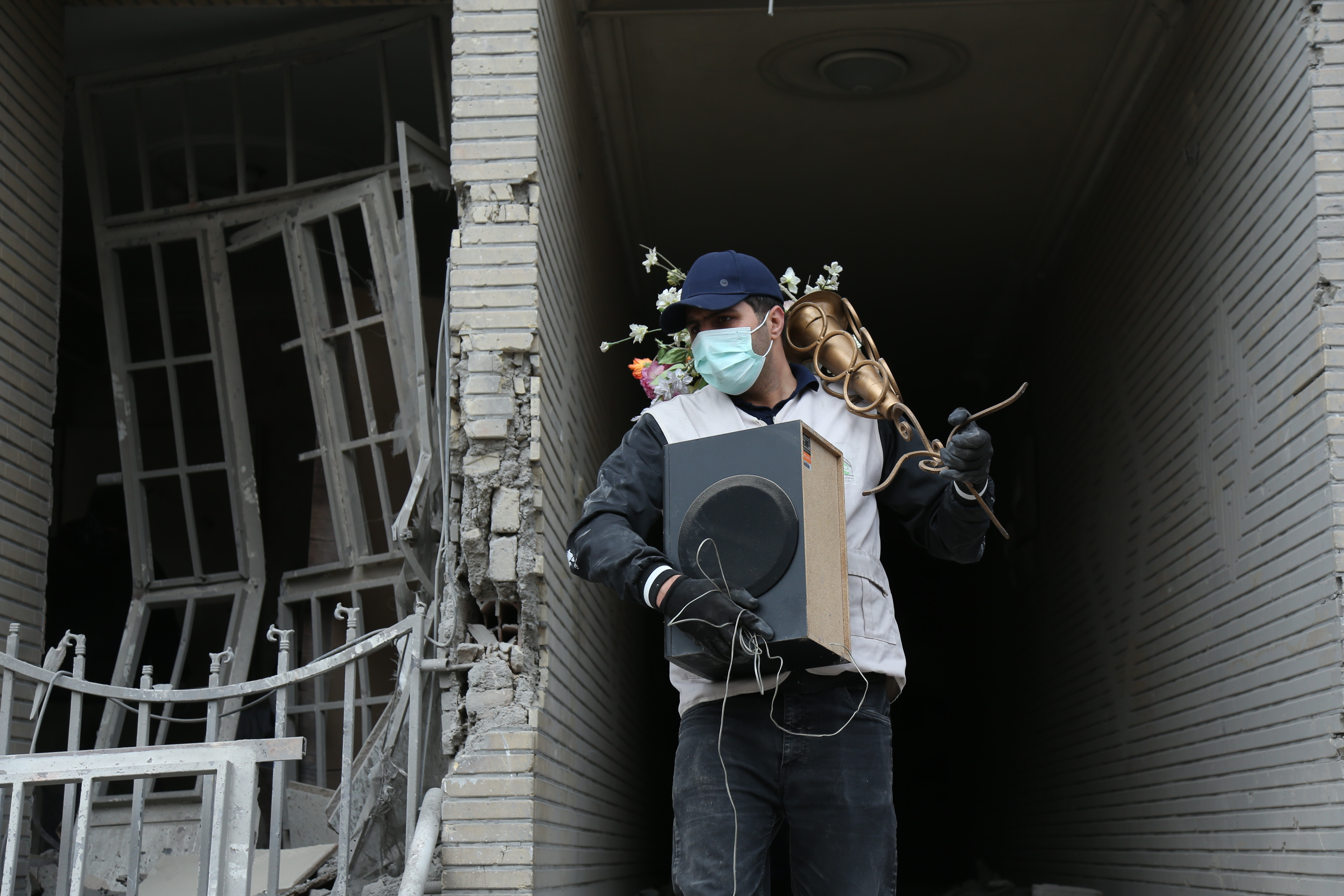 EuropaPress 7367536 beijing march 15 2026    man carries belongings searched from destroyed