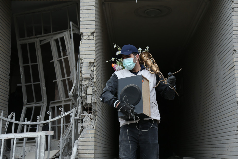 EuropaPress 7367536 beijing march 15 2026    man carries belongings searched from destroyed