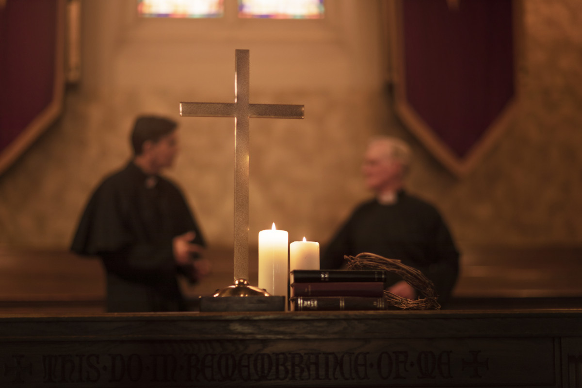 Priests praying together church