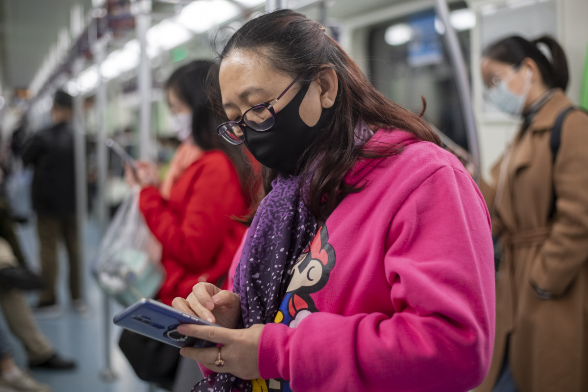 Una dona es protegeix amb una mascareta durant el seu viatge al metro de Xangai.