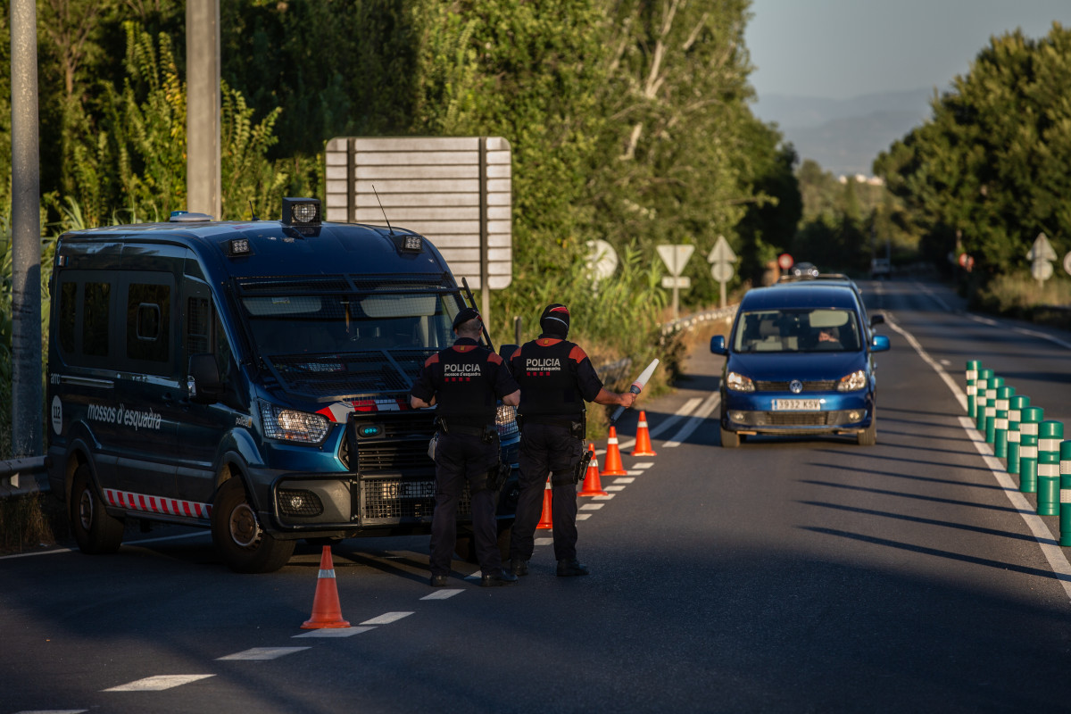 Arxiu - Un Mosso d'Esquadra controla un accés a l'autopista per restriccions de coronavirus (Arxiu)