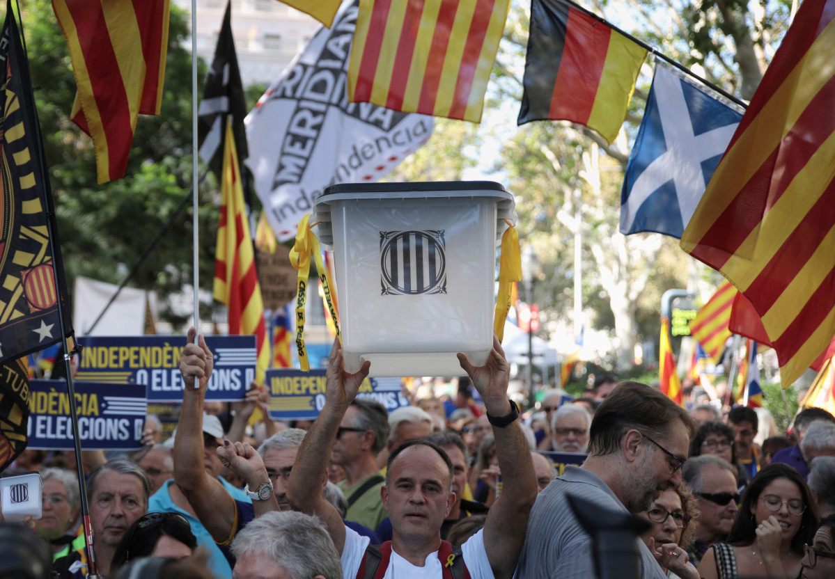 Manifestant alçant una urna a la manifestació de l'ANC pel sisè aniversari de l'1-O